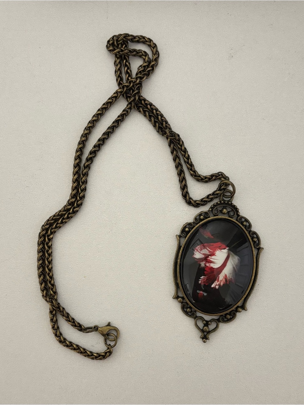 Antique Brass Oval Pendant Necklace with Red and White Feather Art